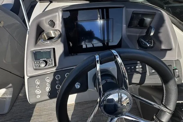 Slide: The Image of 2023 Bennington 27 RSBWA T2 boat dashboard with steering wheel and control panel. - 15