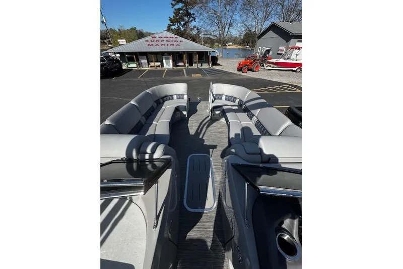 Slide: The Image of 2023 Bennington 27 RSBWA T2 pontoon boat interior with gray seating at marina. - 17