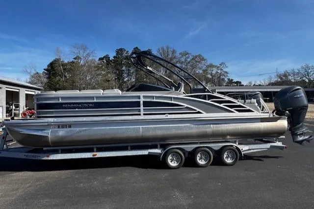 Slide: The Image of 2023 Bennington 27 RSBWA T2 pontoon boat on a trailer, parked outdoors. - 18