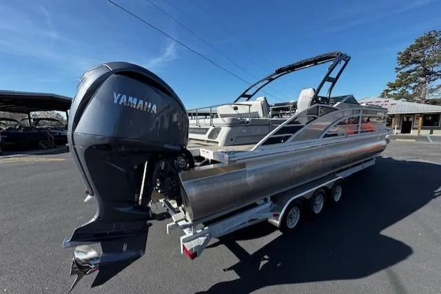 Slide: The Image of 2023 Bennington 27 RSBWA T2 pontoon boat with Yamaha outboard engine on trailer. - 3