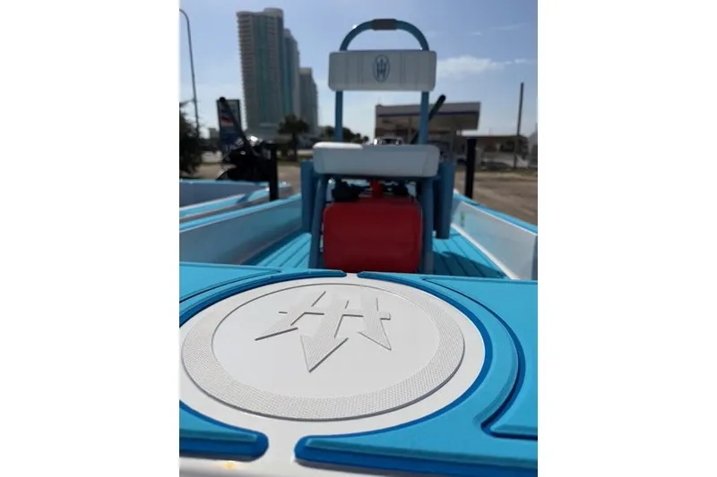 Slide: The Image of 2019 American Marine H:Skiff H13 boat with blue and white interior, cityscape background. - 12