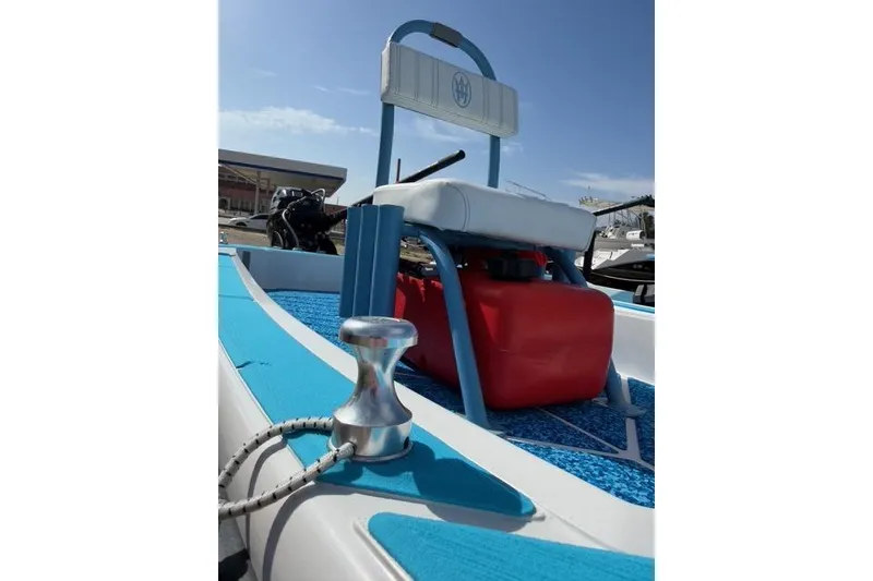 Slide: The Image of 2019 American Marine H:Skiff H13 boat interior with blue accents and red fuel tank. - 14