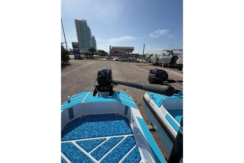 Slide: The Image of 2019 American Marine H:Skiff H13 boat with Mercury engine, parked near a marina. - 16
