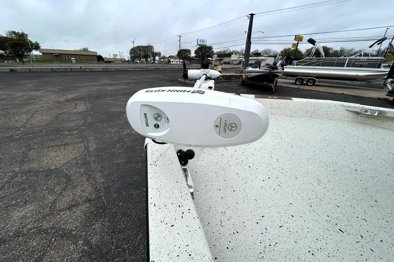 Slide: The Image of 2022 Xpress H20B Bay boat with Minn Kota Riptide trolling motor in parking lot. - 13