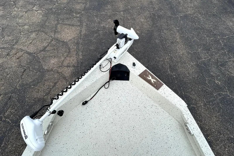 Slide: The Image of 2022 Xpress H20B Bay boat with Minn Kota trolling motor on textured deck. - 14