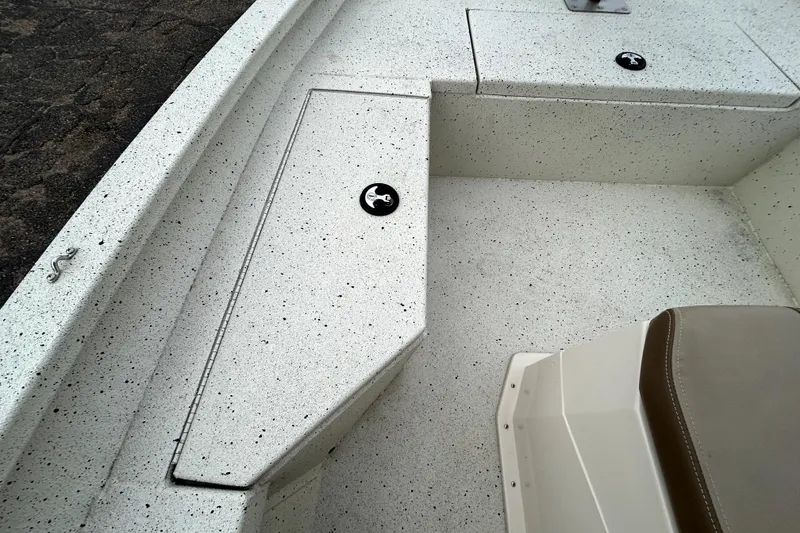 Slide: The Image of 2022 Xpress H20B Bay boat interior with speckled flooring and storage compartments. - 15