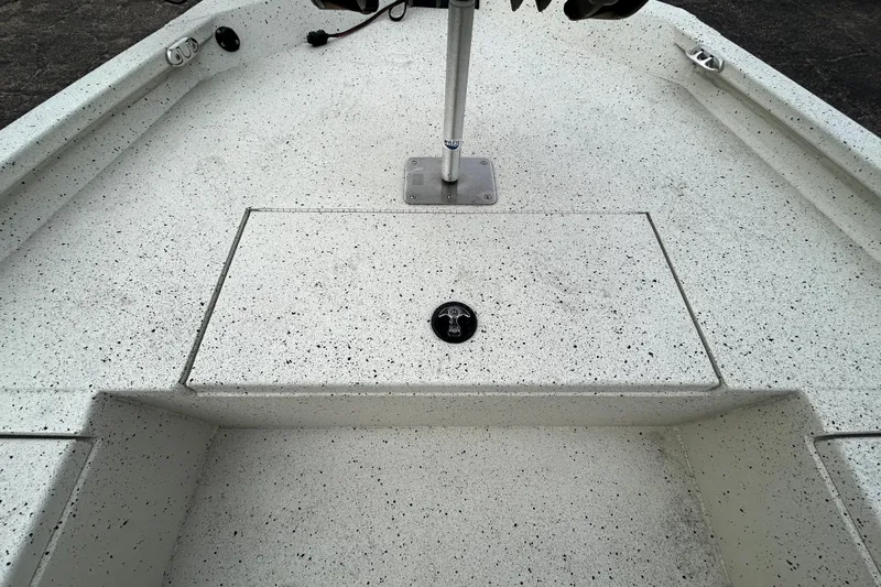 Slide: The Image of 2022 Xpress H20B Bay boat deck with speckled finish and storage compartment. - 17