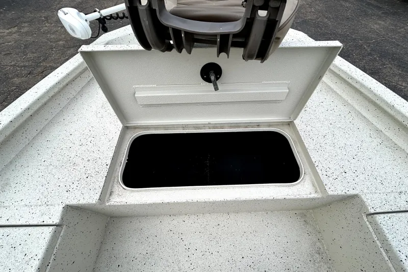 Slide: The Image of 2022 Xpress H20B Bay boat with open storage compartment and mounted seat. - 18