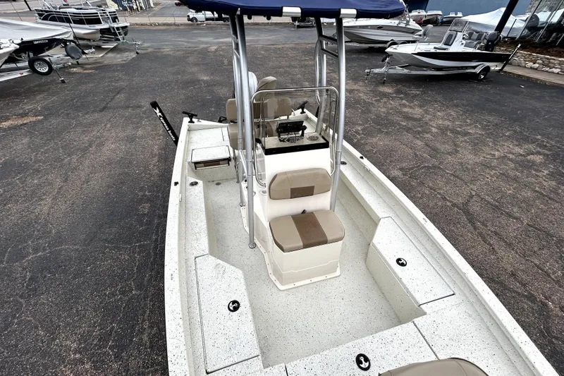 Slide: The Image of 2022 Xpress H20B Bay boat with seating and console, parked on asphalt. - 21
