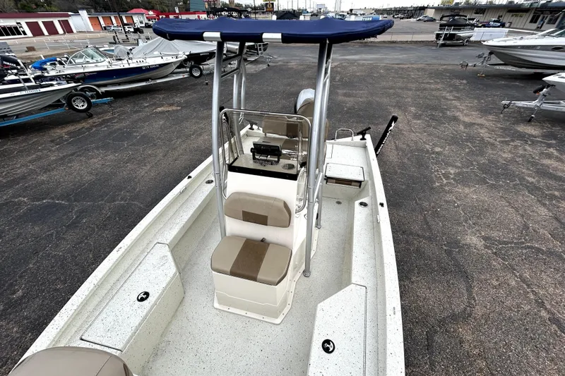 Slide: The Image of 2022 Xpress H20B Bay boat with center console and seating, displayed in a marina. - 22