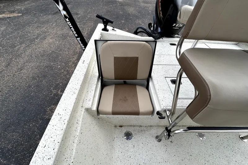 Slide: The Image of 2022 Xpress H20B Bay boat with beige seating and stainless steel fixtures. - 27