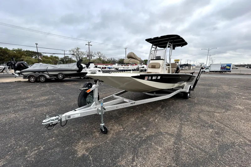 Slide: The Image of 2022 Xpress H20B Bay boat on trailer in parking lot, overcast sky. - 3