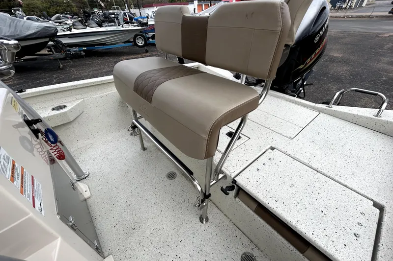 Slide: The Image of 2022 Xpress H20B Bay boat interior with beige seating and Yamaha engine. - 32