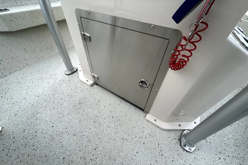 Slide: The Image of 2022 Xpress H20B Bay boat interior with storage compartment and safety lanyard. - 35