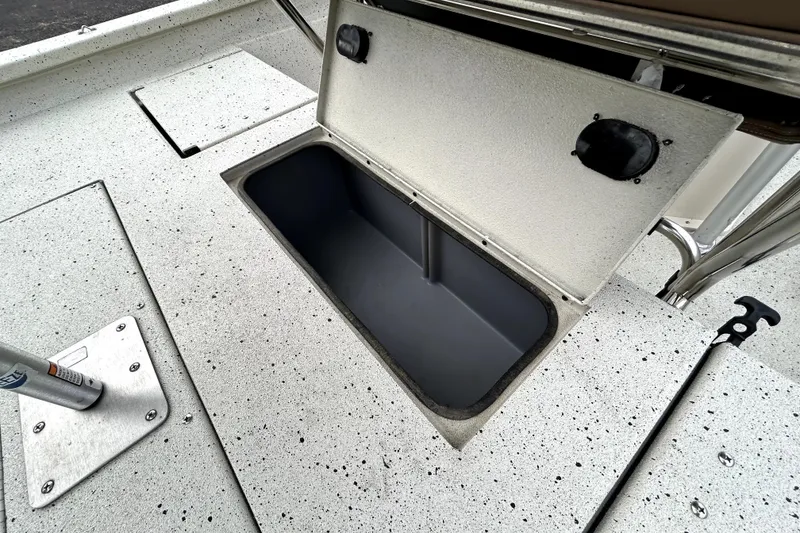 Slide: The Image of 2022 Xpress H20B Bay boat storage compartment with open hatch on speckled deck. - 38