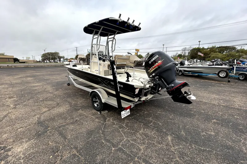Slide: The Image of 2022 Xpress H20B Bay boat with Yamaha outboard motor on trailer in parking lot. - 5