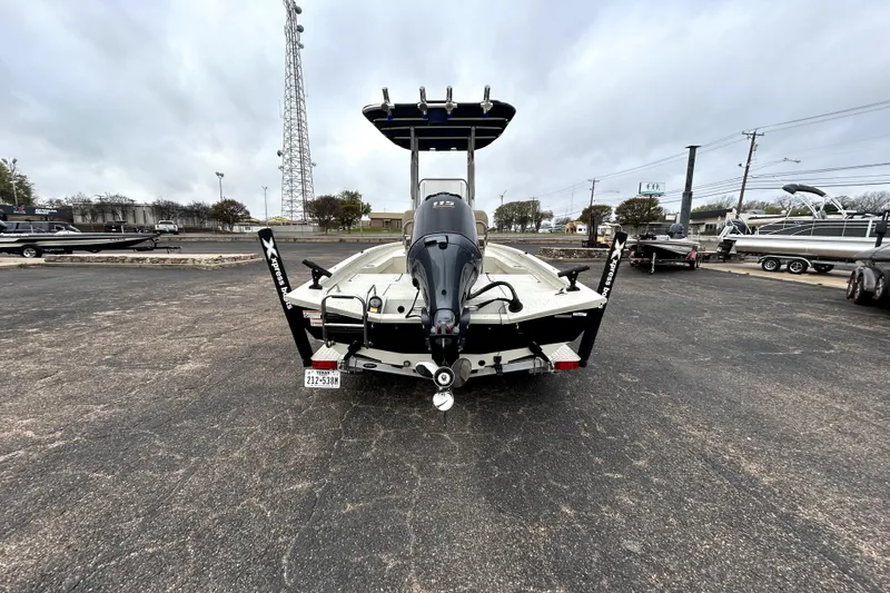 Slide: The Image of 2022 Xpress H20B Bay boat with outboard motor, parked in a lot. - 6