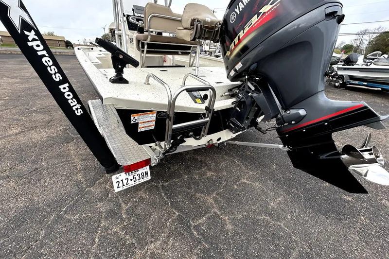 Slide: The Image of 2022 Xpress H20B Bay boat with Yamaha outboard motor, parked on asphalt. - 8