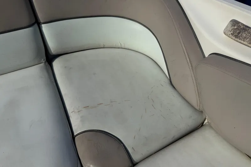 Slide: The Image of Worn seating on 2004 Sea Ray 240 Sundeck boat, showing signs of use and aging. - 12