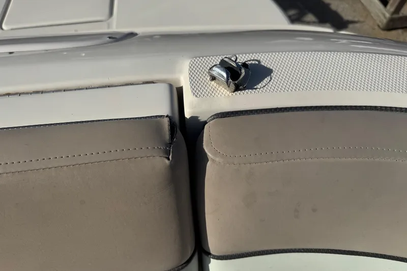 Slide: The Image of 2004 Sea Ray 240 Sundeck boat seating with cleat, beige upholstery. - 13