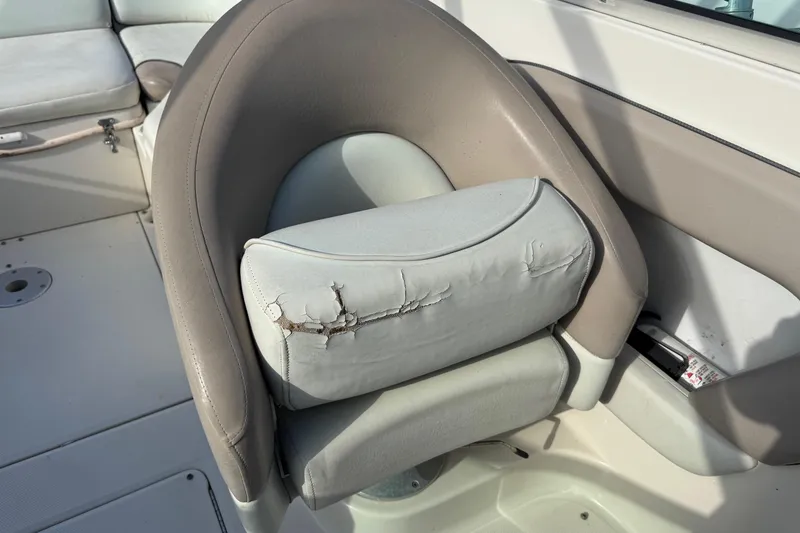 Slide: The Image of Worn seat on 2004 Sea Ray 240 Sundeck boat, showing cracked upholstery. - 14