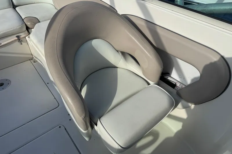 Slide: The Image of 2004 Sea Ray 240 Sundeck boat seat, beige and white upholstery, close-up view. - 15