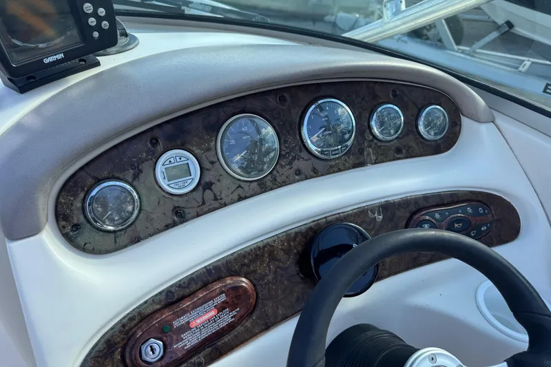 Slide: The Image of Dashboard of a 2004 Sea Ray 240 Sundeck boat with gauges and controls. - 19