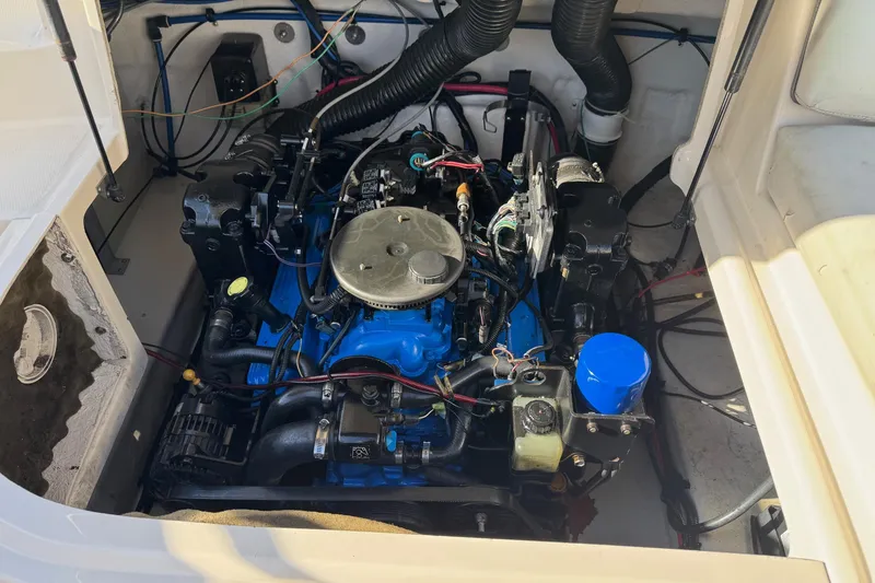 Slide: The Image of Engine compartment of a 2004 Sea Ray 240 Sundeck boat, showcasing detailed components. - 31