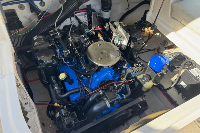 Slide: The Image of Engine compartment of a 2004 Sea Ray 240 Sundeck boat, showcasing detailed components. - 32