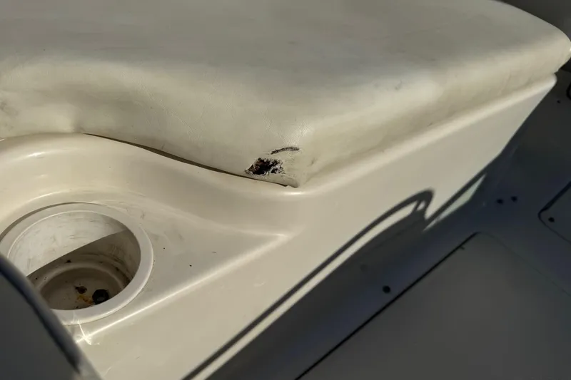 Slide: The Image of Damaged seat on 2004 Sea Ray 240 Sundeck boat, showing wear and tear. - 33