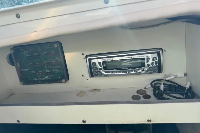 Slide: The Image of Control panel and marine CD receiver in a 2004 Sea Ray 240 Sundeck boat. - 35