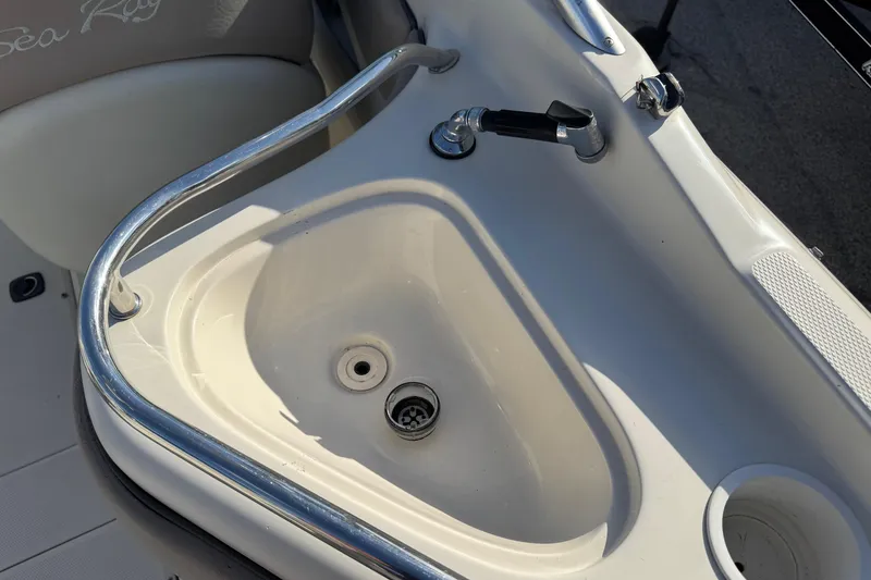 Slide: The Image of 2004 Sea Ray 240 Sundeck sink with faucet and cup holder on deck. - 8