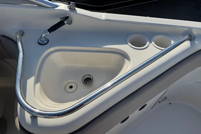 Slide: The Image of 2004 Sea Ray 240 Sundeck boat sink with faucet and cup holders. - 9