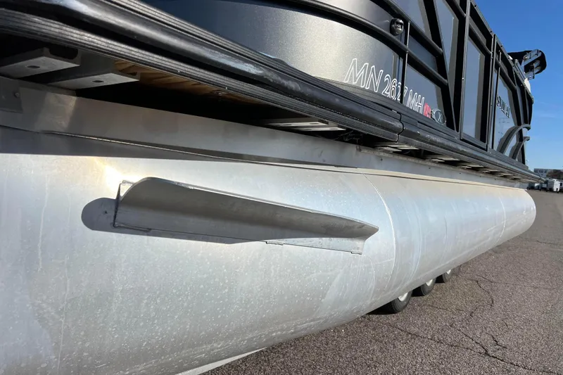 Slide: The Image of 2022 Sylvan Mirage X1 Tritoon pontoon boat, side view, showing aluminum hull detail. - 11