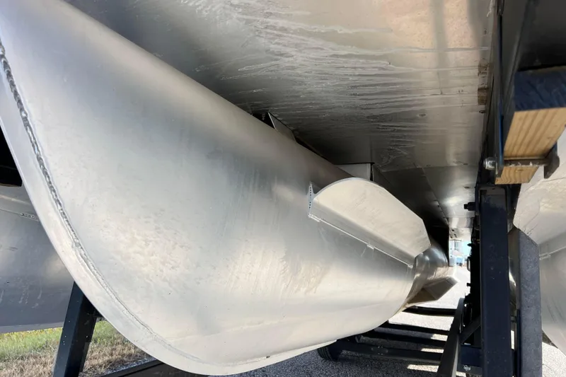 Slide: The Image of Underneath view of 2022 Sylvan Mirage X1 Tritoon, showcasing its sleek aluminum pontoons. - 12