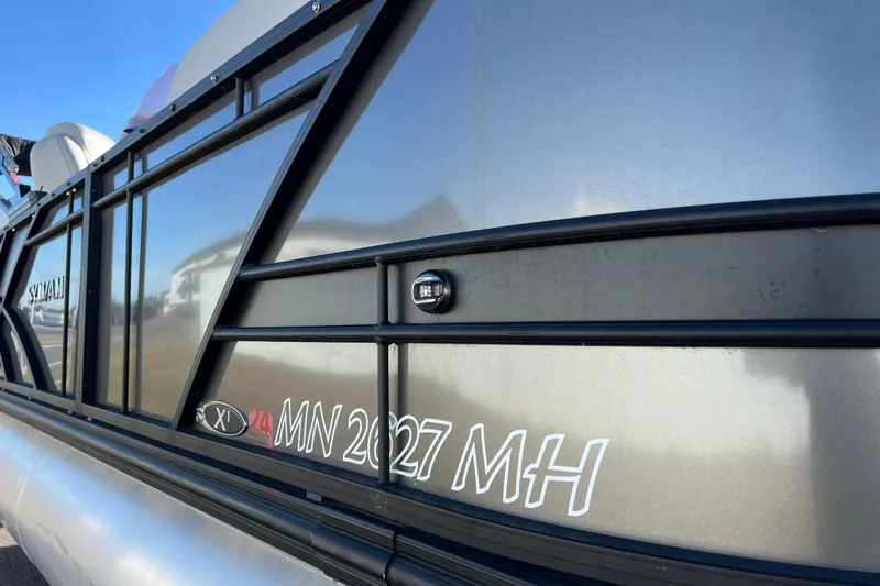 Slide: The Image of 2022 Sylvan Mirage X1 Tritoon boat side view with registration number. - 14