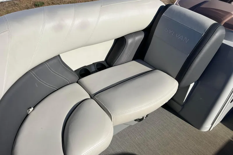 Slide: The Image of 2022 Sylvan Mirage X1 Tritoon boat seating with gray and white upholstery. - 19