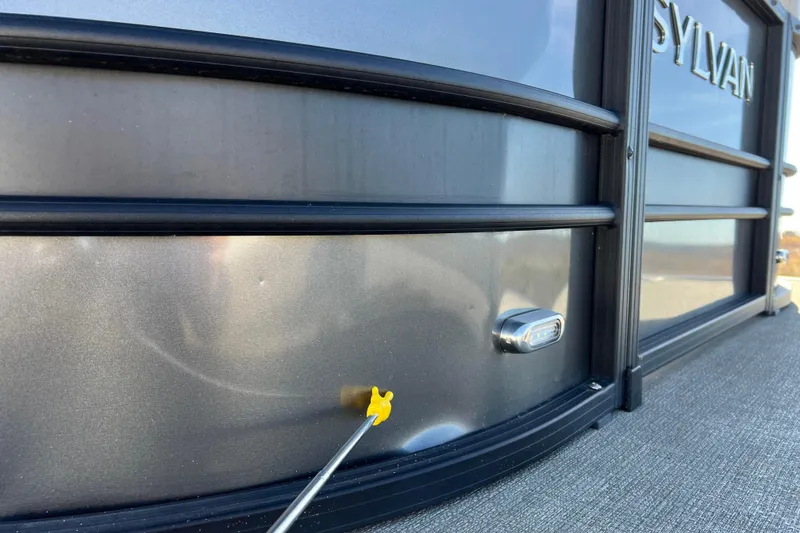 Slide: The Image of 2022 Sylvan Mirage X1 Tritoon exterior detail with dent and inspection tool. - 38