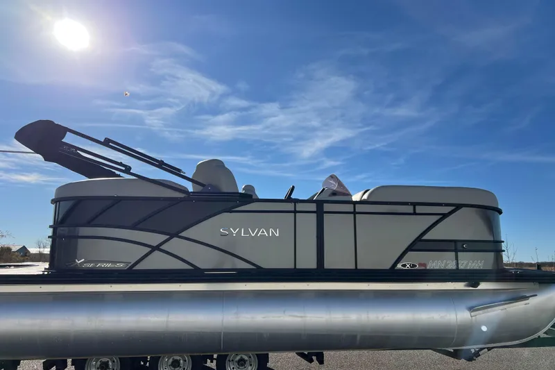 Slide: The Image of 2022 Sylvan Mirage X1 Tritoon boat under clear blue sky. - 6