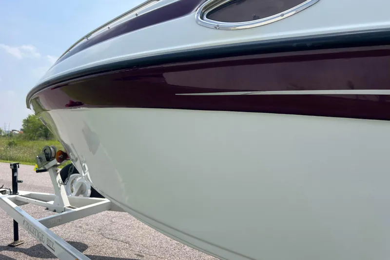 Slide: The Image of 2003 Crownline 230 BR boat on trailer, close-up of hull and trim details. - 25