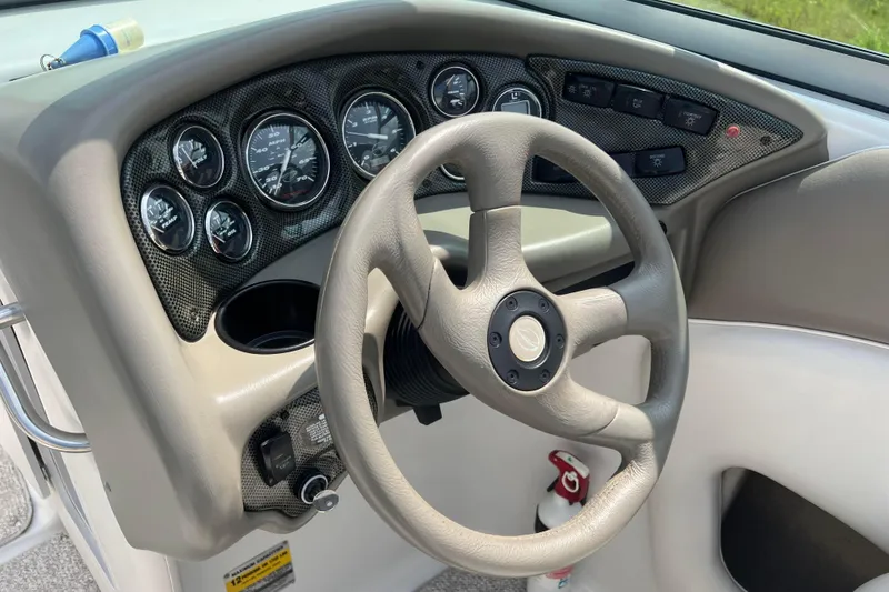 Slide: The Image of Dashboard of 2003 Crownline 230 BR boat with steering wheel and gauges. - 36