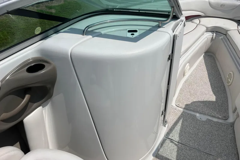 Slide: The Image of 2003 Crownline 230 BR boat interior with seating and storage area. - 47