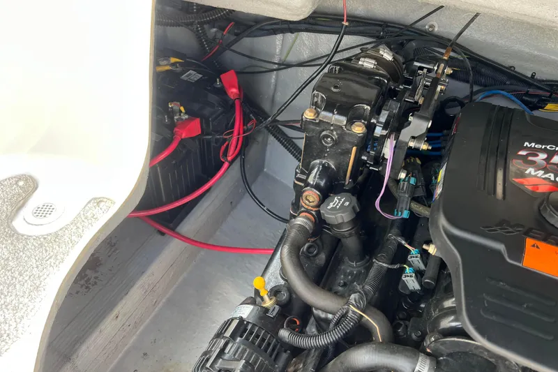 Slide: The Image of Engine compartment of a 2003 Crownline 230 BR boat, featuring a MerCruiser 350 MAG engine. - 63