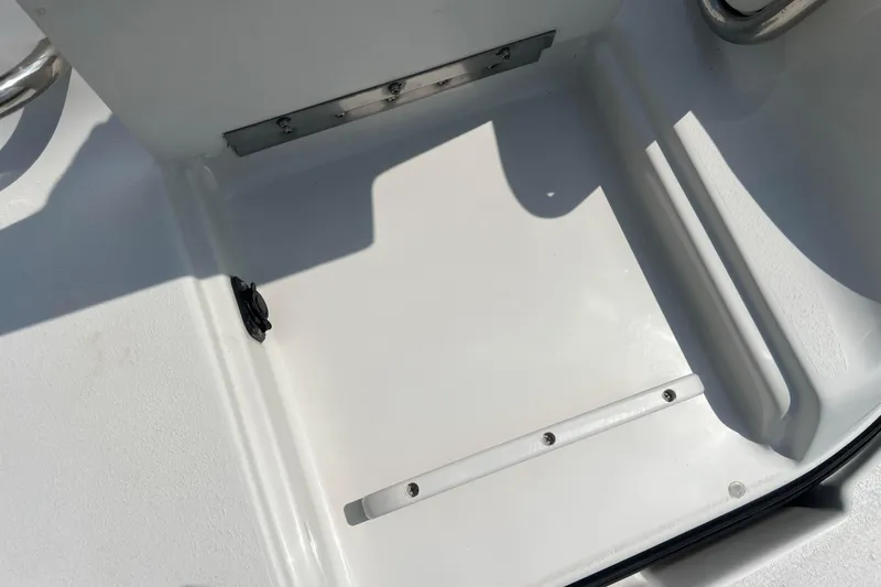 Slide: The Image of 2003 Crownline 230 BR boat interior detail, featuring a clean white surface and metal fixtures. - 68