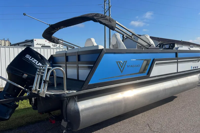 Slide: The Image of 2022 Viaggio Diamante Q pontoon boat with Suzuki outboard motor, blue and white design. - 4