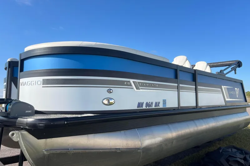 Slide: The Image of 2022 Viaggio Diamante Q pontoon boat with sleek design under clear blue sky. - 7