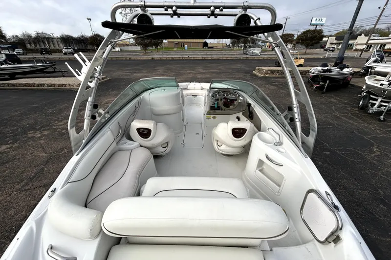 Slide: The Image of 2005 Crownline 220 LS boat interior with white seating and dashboard view. - 10