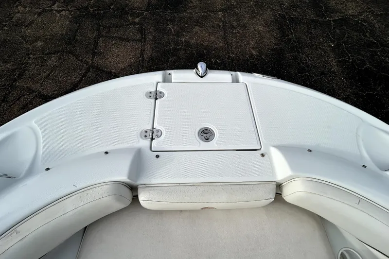 Slide: The Image of 2005 Crownline 220 LS boat bow seating area with storage compartment. - 14