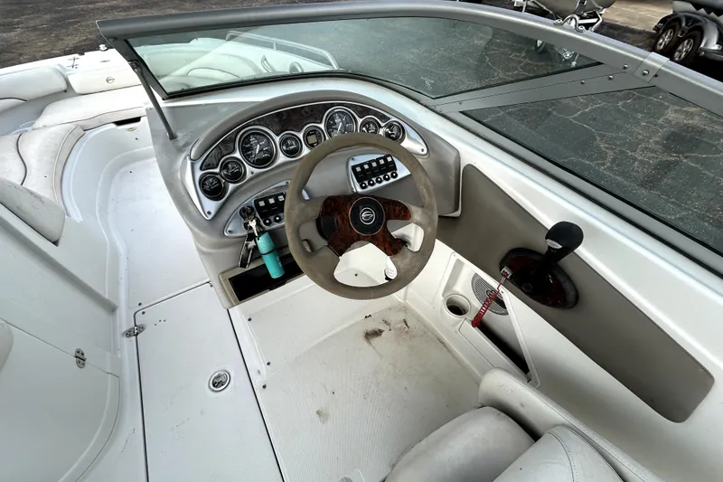 Slide: The Image of 2005 Crownline 220 LS boat dashboard with steering wheel and control panel. - 19