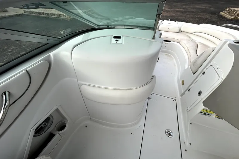 Slide: The Image of 2005 Crownline 220 LS boat interior with white seating and dashboard. - 20